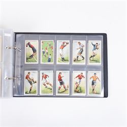 Collection of Edwardian and later Football related trading and cigarette cards, including forty-nine of fifty 1906 Ogden's Football Club Colours, 1922 PALS Footall series, ninety of one hundred 1925 Gallaher Famous Footballers, complete set of forty-four 1926 Ogden's Captains of Association Football Clubs and Colours, complete set of fifty 1927 Players Football Caricatures by MAC,  complete set of fifty 1927 Players Football Caricatures by RIP,  complete set of fifty 1930 Players Association Cup Winners, complete set of 50 1933 Ogdens AFC Nicknames etc, housed in brown cigarette card album