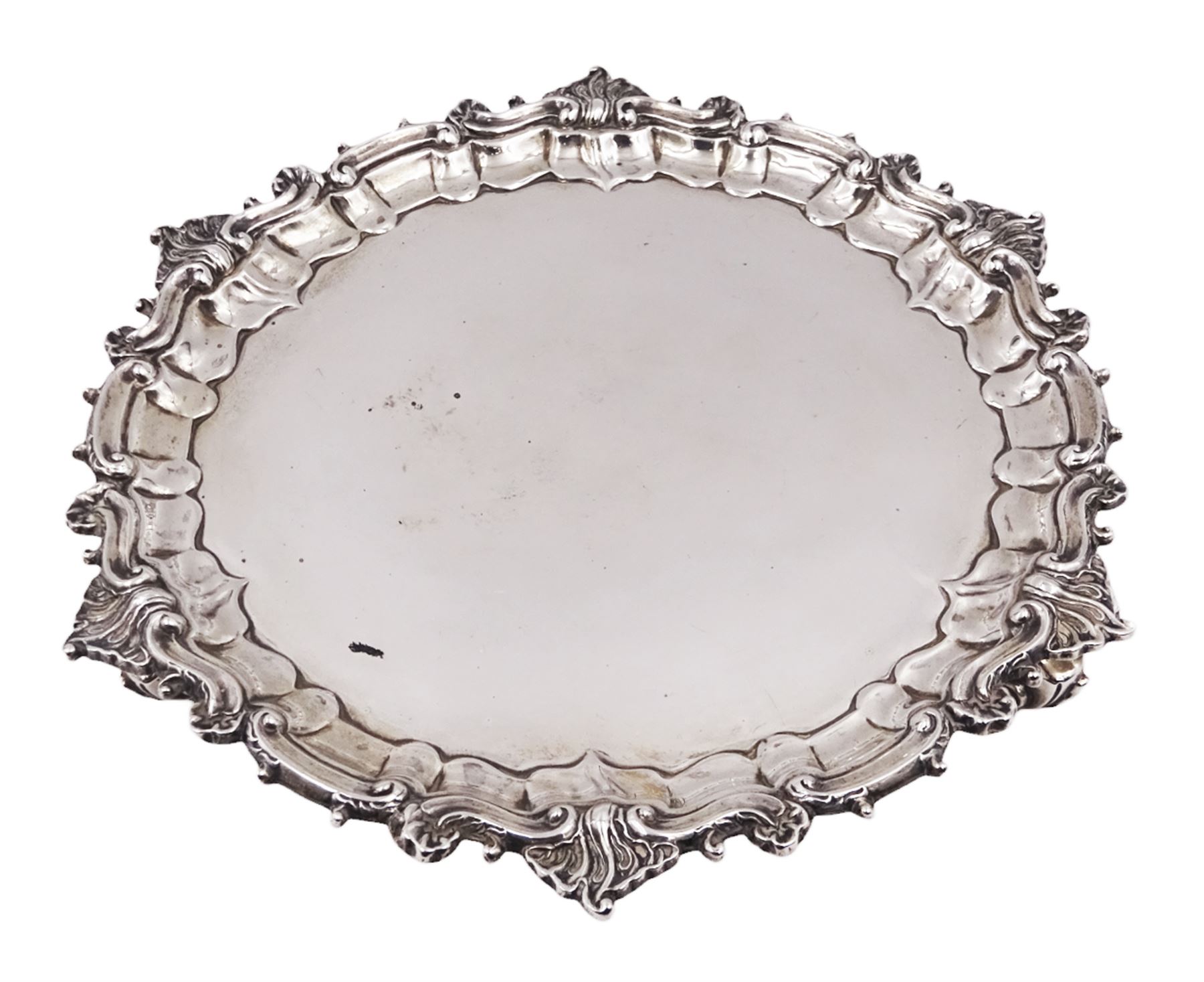 Victorian silver waiter, of typical form, with shaped rim embossed with C scrolls, upon three scroll feet, hallmarked Sibray, Hall & Co, London 1898, D18.5cm