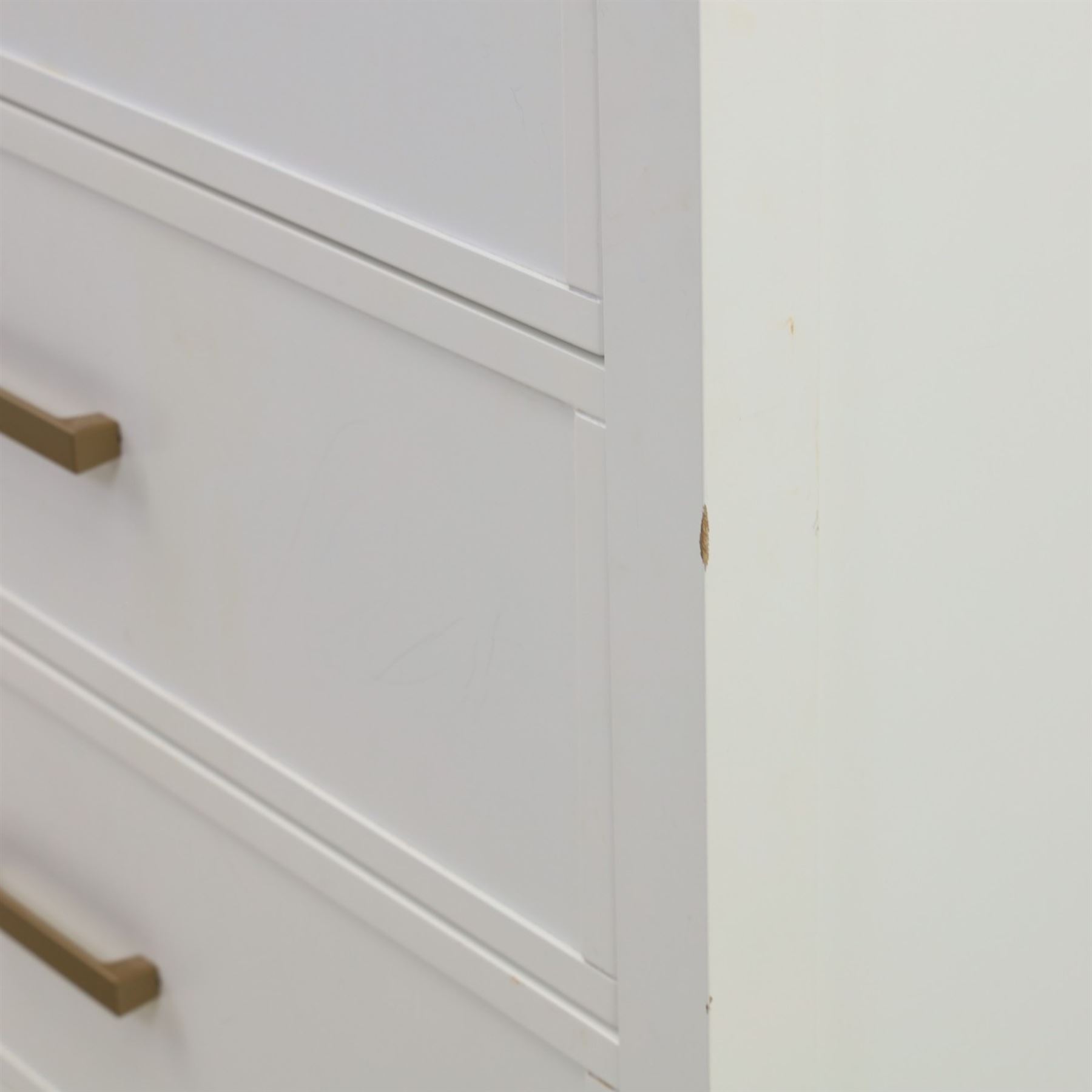 Dorel Home - Modern chest of drawer, white painted rectangular top above, four drawers with bronze metal handles, on tapered supports 