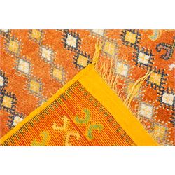 North Persian tribal rug, an orange field and six rows of lozenges, with a border of ram's horn motifs