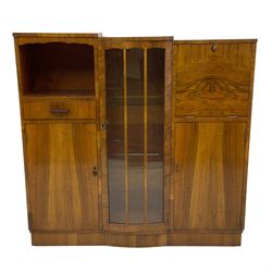 Early 20th century walnut side cabinet, enclosed by central bowed and glazed door, fitted with drawer, two cupboards and fall front, on plinth base