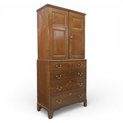 18th century oak press cupboard on chest, the moulded cornice above a pair of fielded panel doors enclosing shelved interior, the base fitted with four long graduated drawers with brass swan neck handles and shaped escutcheons, raised on bracket feet