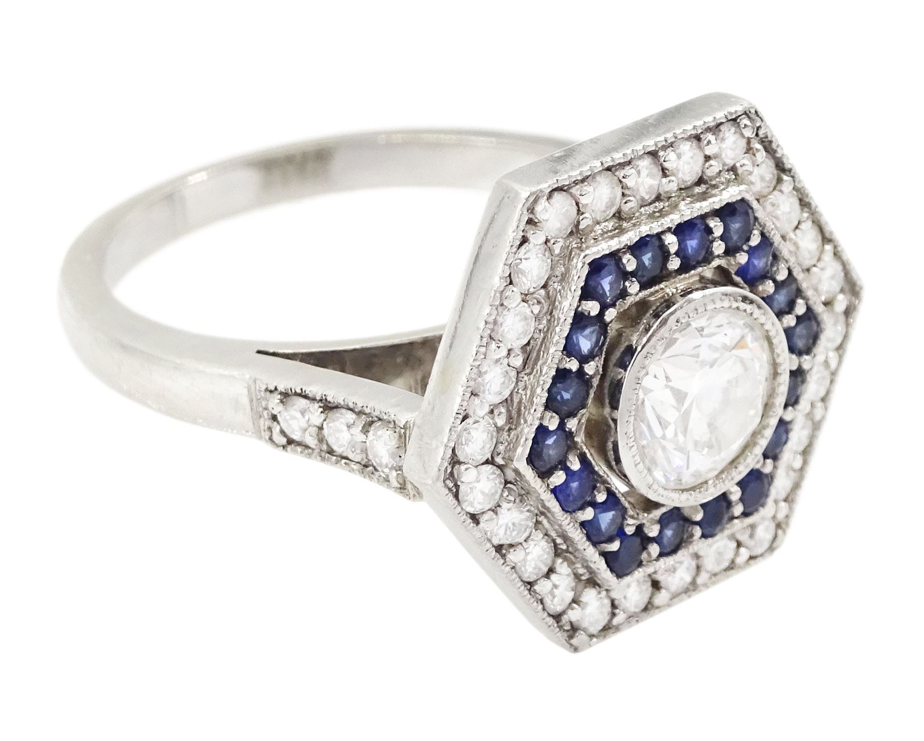 Platinum diamond and sapphire hexagonal ring, the principle diamond of approx 0.55 carat, with sapphire and round brilliant cut diamond surround, all milgrain set, hallmarked