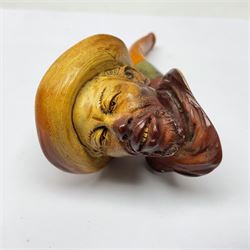 Carved Meerschaum pipe, depicting a man in a hat, with amber mouth piece, together with two cheroot holders, all within tooled leather cases