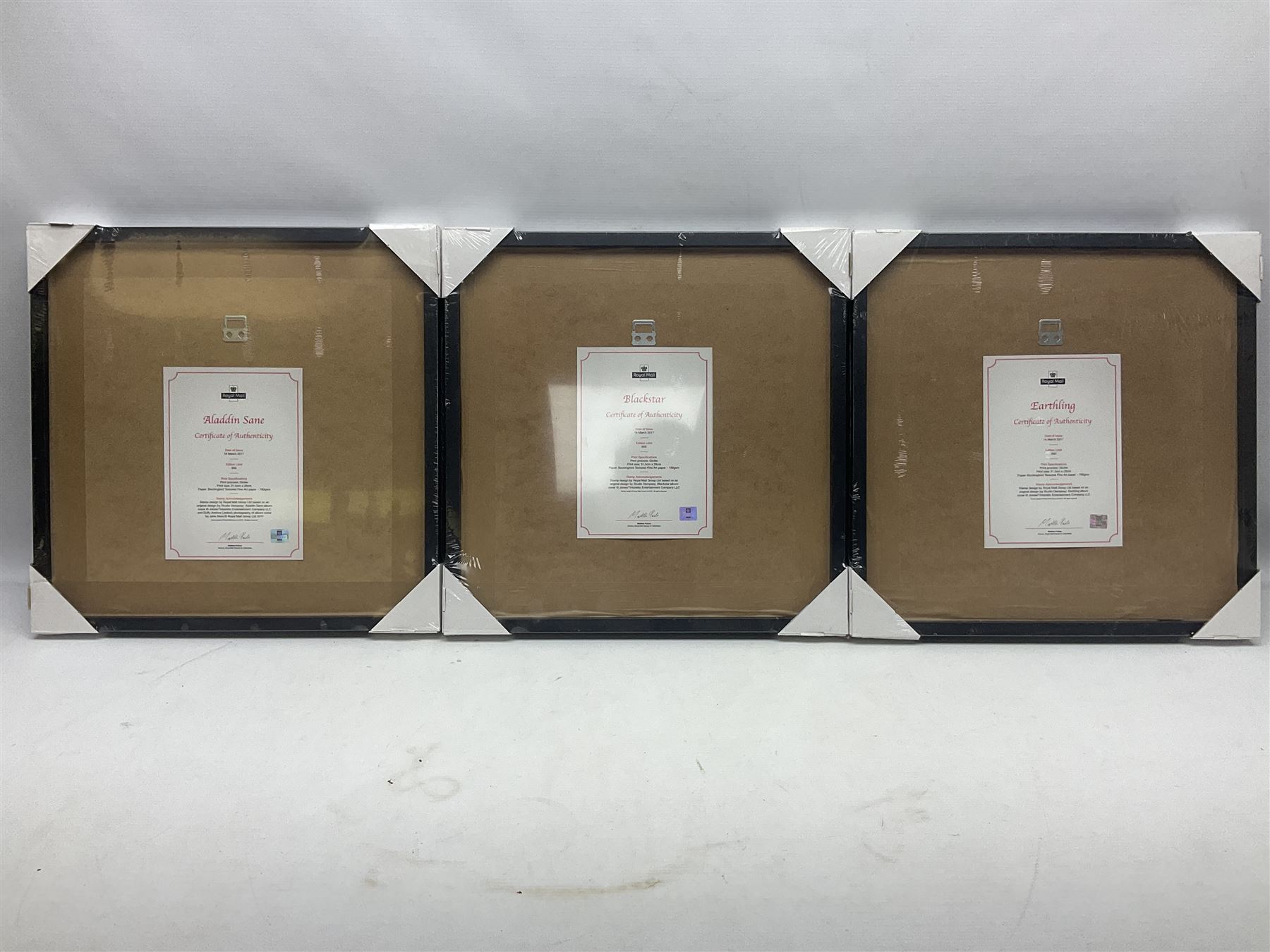 Set of three Royal Mail David Bowie limited edition album stamp prints, comprising Aladdin Sane, Blackstar and Earthling, all framed and in original packaging, H43cm W43cm