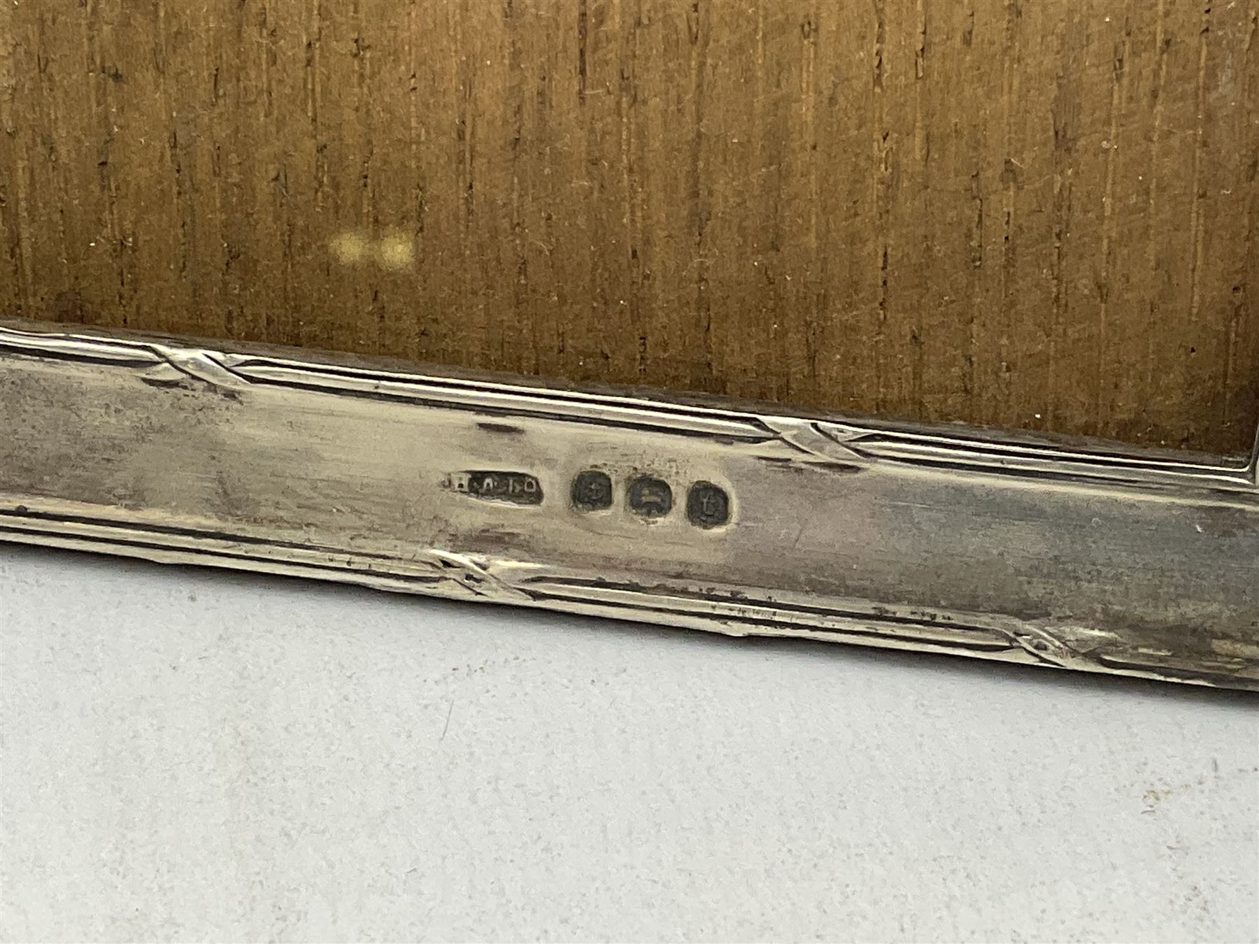 Edwardian silver stand, of square shaped form, upon four bun feet, hallmarked Birmingham 1907, together with an early 20th century silver mounted photograph frame, hallmarked Birmingham 1918, approximate weighable silver 93.6 grams