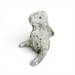 Two weathered cast stone garden hares
