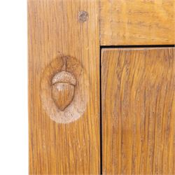 Acornman - oak adzed panelled double wardrobe, with wrought iron hinges and carved oak latch revealing a single clothes rail, with signature carved acorn to top left, by the workshop of Alan Grainger, Brandsby