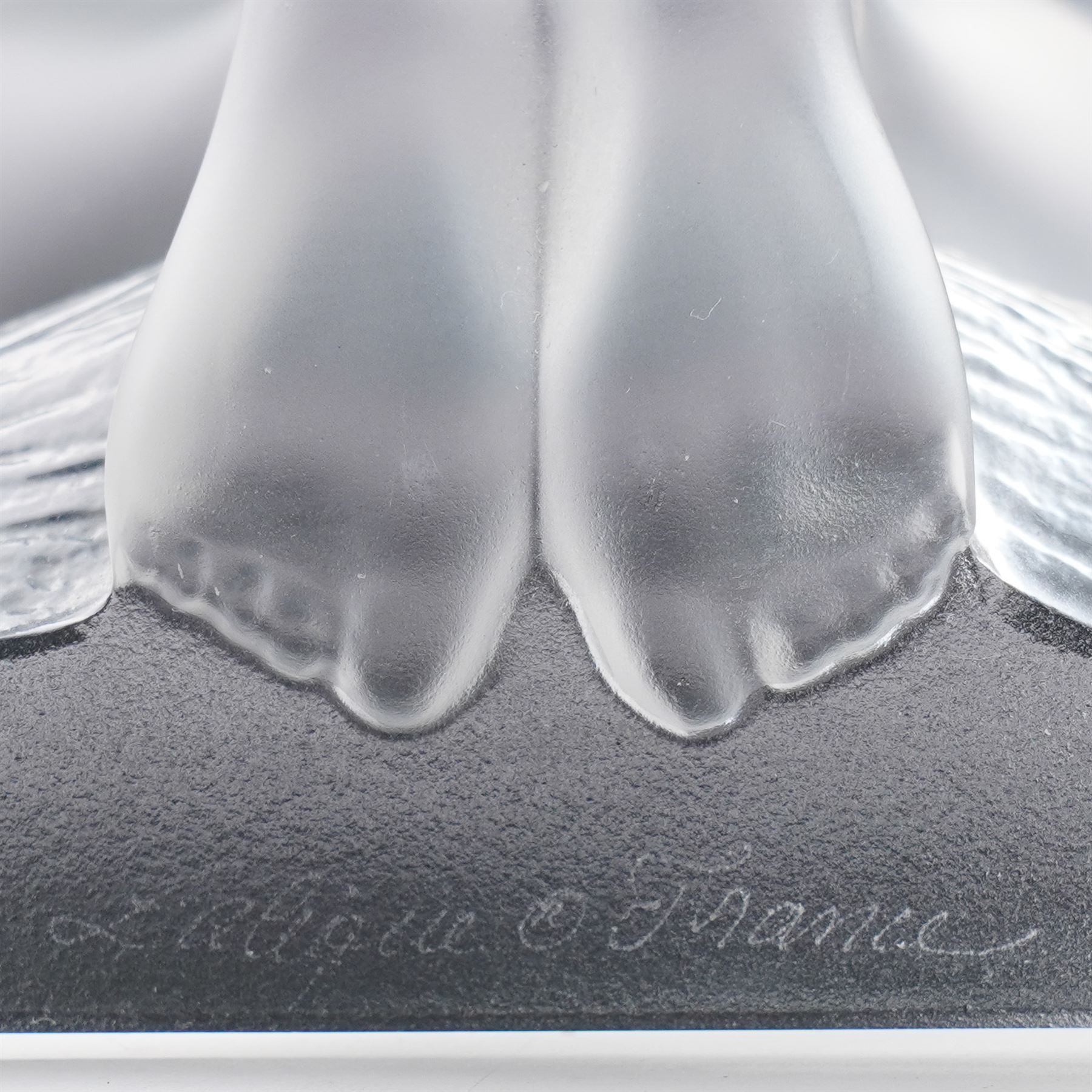Pair of Lalique 'Reverie' glass bookends formed as two kneeling nude figures in clear and frosted glass inscribed 'Lalique France' to the plinth base H23cm