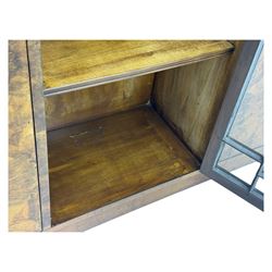 Art Deco burr walnut drinks cabinet, geometric central glazed astragal door enclosing two fixed shelves, flanked by symmetrical bookmatched veneered cupboards with drawers above 