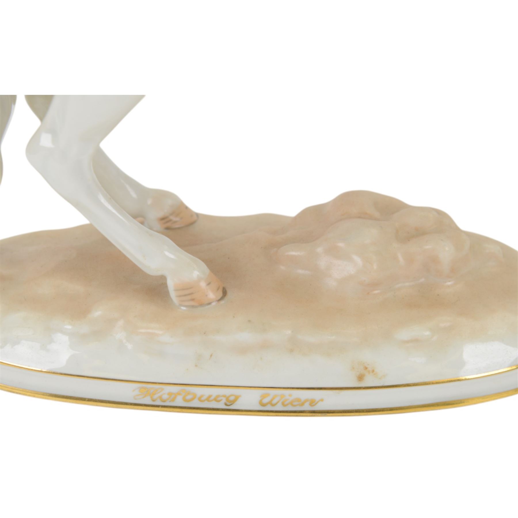 Royal Vienna Augarten figurine, modelled a Spanish Riding School rider upon rearing horse, with Trab-Spanische Reitschule Hofburg Wien in gilt to the base, H30cm