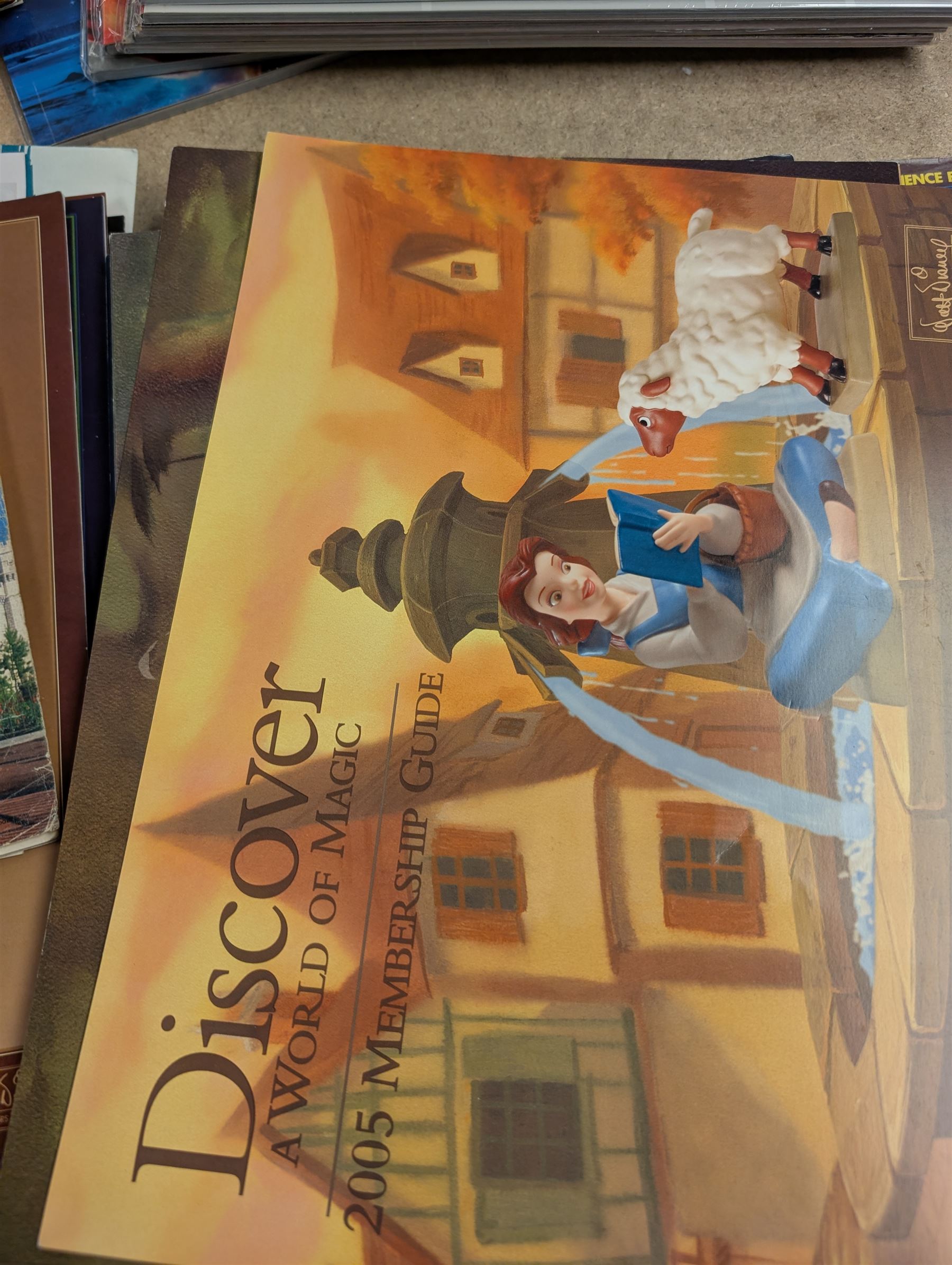 Collection of Disney memorabilia and ephemera, including Walt Disney Treasures DVD, two Disney Villains mugs, enamel pins, Mickey Mouse D23 fan club pack, Disney Twenty-Three magazines, Sketches magazines, etc