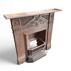 Late Victorian cast ion bedroom fireplace, decorated with floral poppy motifs and flluting