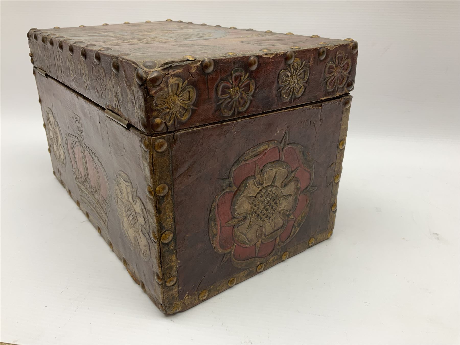 20th century box, decorated in faux leather with the royal coat of arms and GR 1719 to hinged cover, with fleur-de-lis, lion, crown and rose motifs throughout and studs to all edges, opening to reveal a purple velvet interior containing three removable wooden trays, H18.5cm