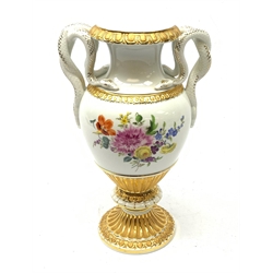  A Meissen twin handled vase, of baluster form with waisted neck, serpent modelled handles, and raised upon a spreading circular foot, hand painted with floral sprays and heightened with gilt, with crossed swords mark beneath, H26.5cm.  