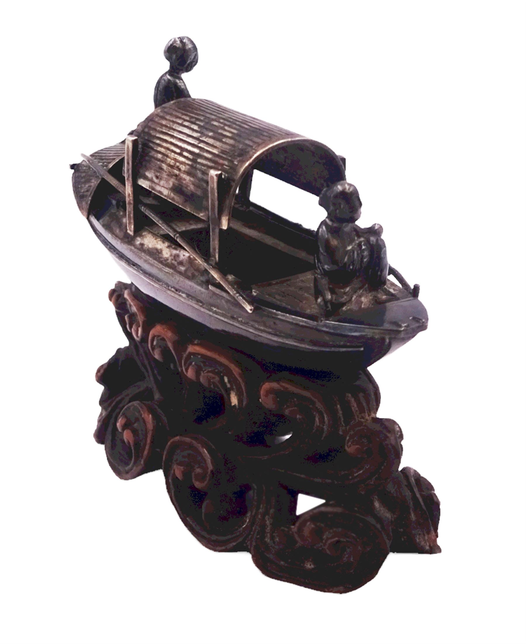 Chinese miniature silver model of a junk, with character mark to stern, mounted upon a carved wooden stand, overall H5cm L6.5cm