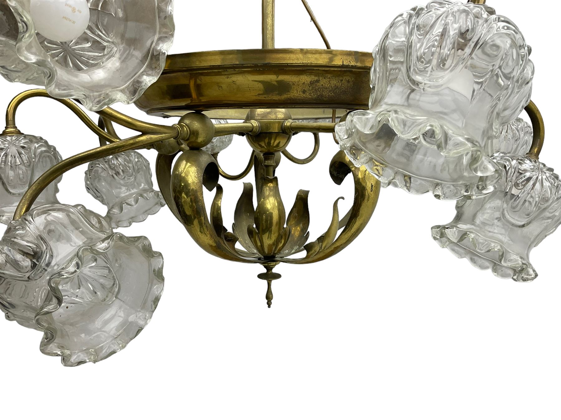 Mid-20th century brass lightolier or light fitting, the scrolling foliate branches connected with a central ring, terminating in ten tulip shaped cut glass sades, pointed terminal beneath