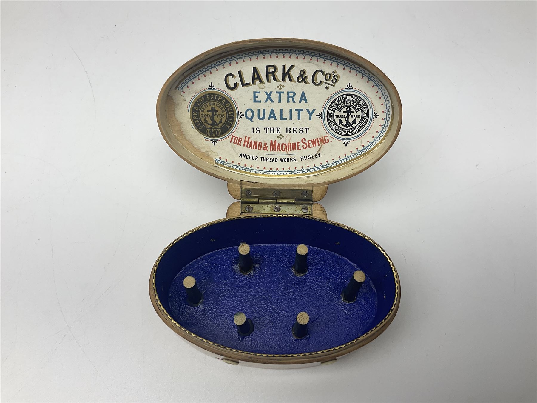 Six sewing related Mauchline ware comprising an oval reel box with internal label for Clark & Co's, tape measure, pin case and three thimble holders of ovoid form 