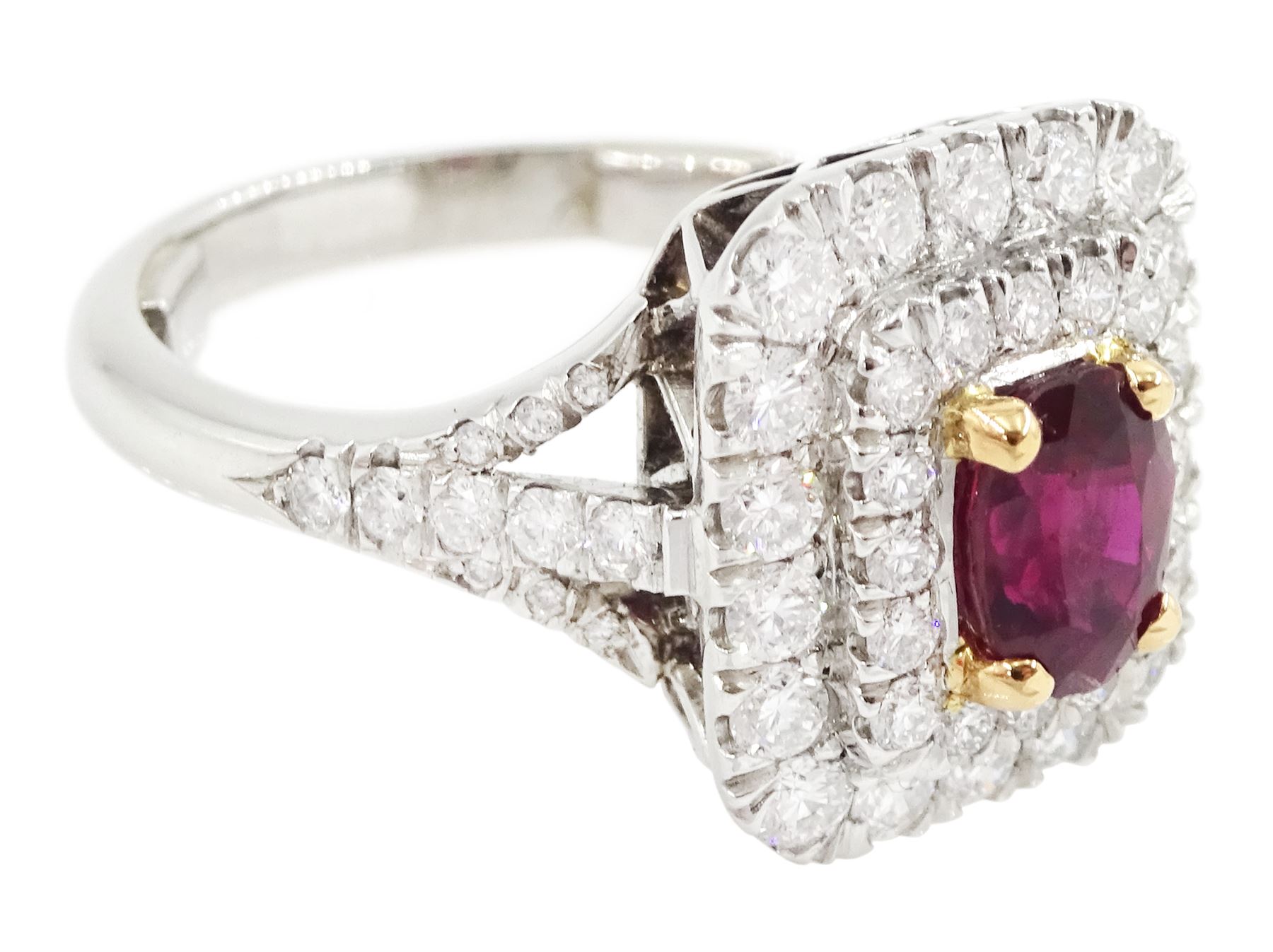 Platinum ruby diamond cluster ring, single oval cut ruby  in a four claw 18ct rose gold setting of approx 1.02 carat, surrounded by two rows of round brilliant cut diamonds and split diamond set shoulders, London 2017, total diamond weight approx 0.76 carat, with Alan Poultney Gems report