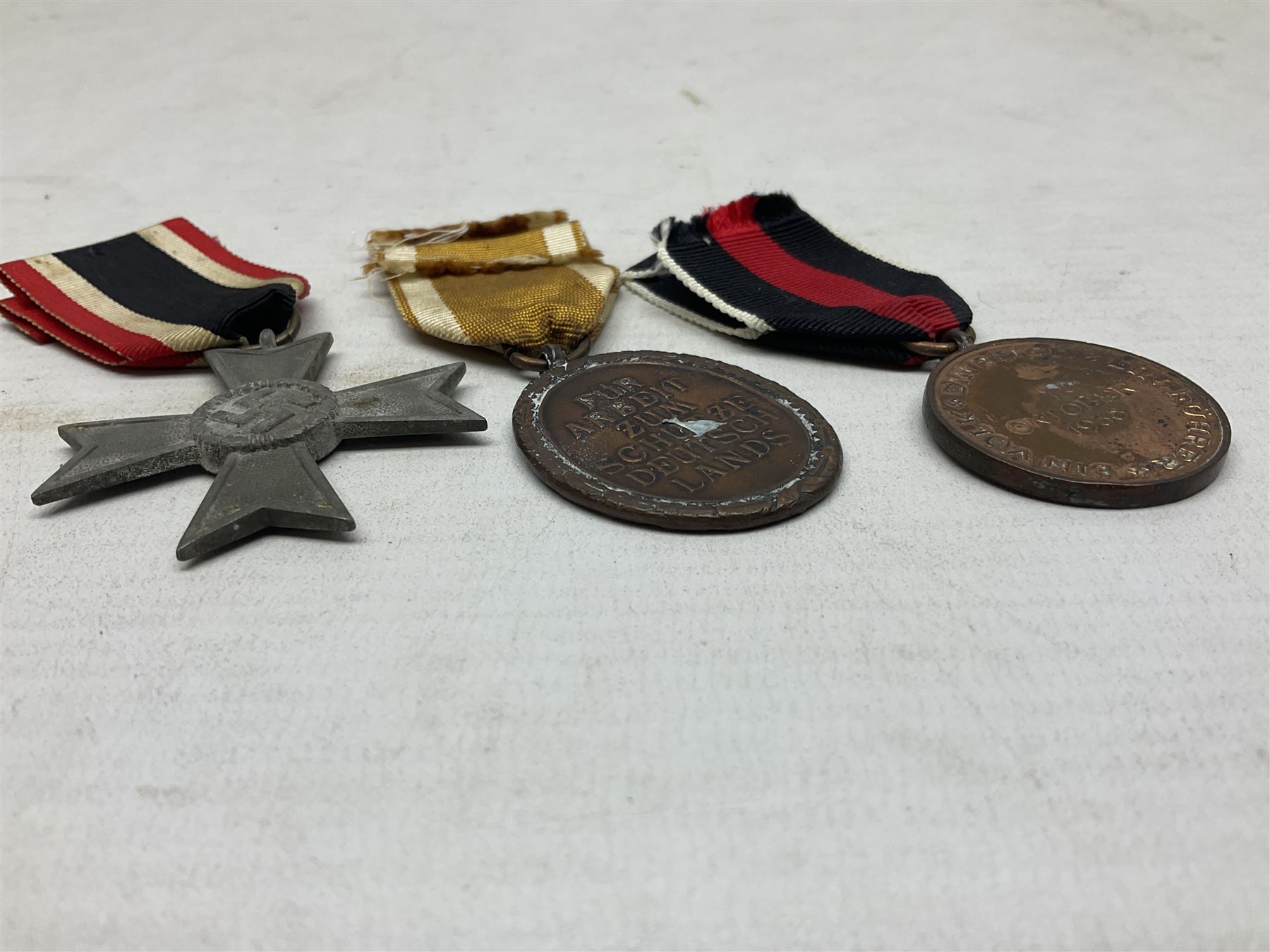 Three WW2 German medals - Defences Medal, Czech Occupation Commemorative Medal and War Merit Cross; all with ribbons (3)