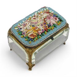 Micro mosaic jewellery casket with bevelled glass sides, the hinged lid decorated with with multicoloured raised flowers upon a blue ground, raised upon pierced gilt feet H10cm, L15cm