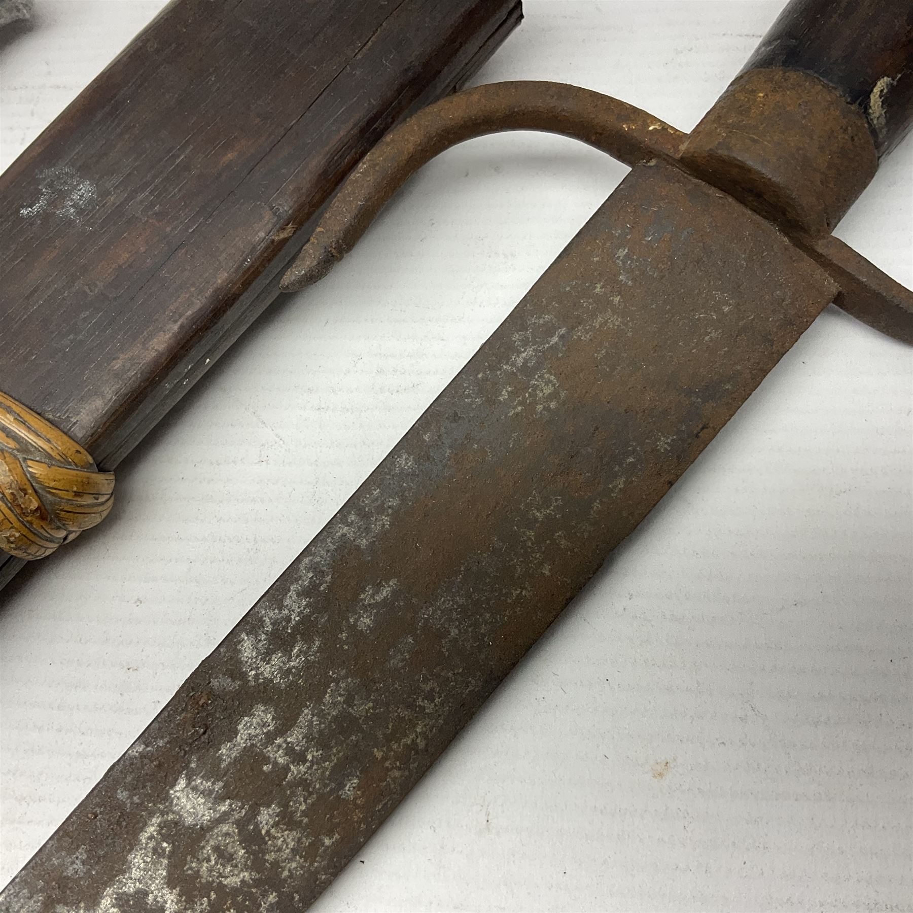  British Private Purchase fighting knife by William Rodgers, Sheffield, the 15cm double edge steel blade with raised medial ridge, stamped on one side of the ricasso WILLIAM RODGERS I CUT MY WAY, the opposing side marked MADE IN SHEFFIELD, ENGLAND, with aluminium crossguard and pommel, stacked leather washers grip and leather scabbard L27.5cm overall; and a crudely made short sword with 32.5cm single edged blade and steel knucklebow hilt with hardwood grip; in cane bound wooden scabbard L45cm overall (2)