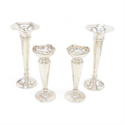 Two pairs of early 20th century silver vases, comprising pair of Edwardian trumpet vases with fluted rims upon a circular domed foot, hallmarked S Blanckensee & Son Ltd, Chester 1907, and a smaller 1920s pair, hallmarked Chester 1920, maker's mark worn and indistinct, tallest H19cm