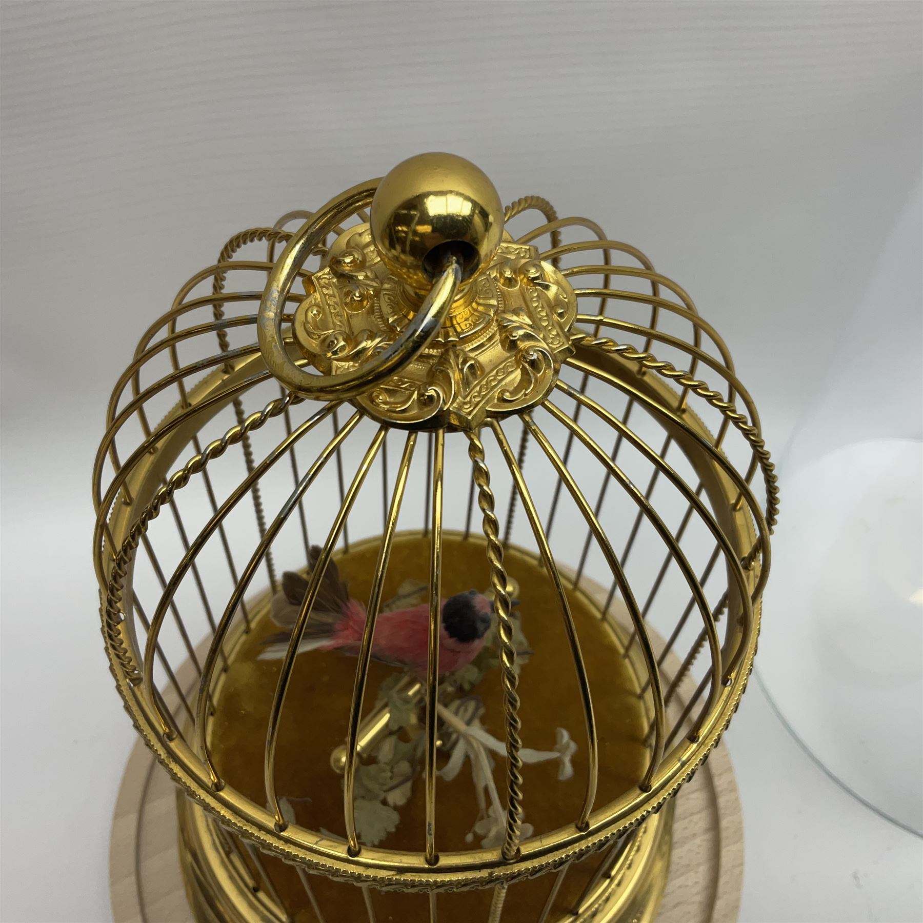 Swiss Reuge Music bird cage automaton music box, the bird with articulated head and beak, in a gilt brass cage, with a glass dome and stand, H30cm