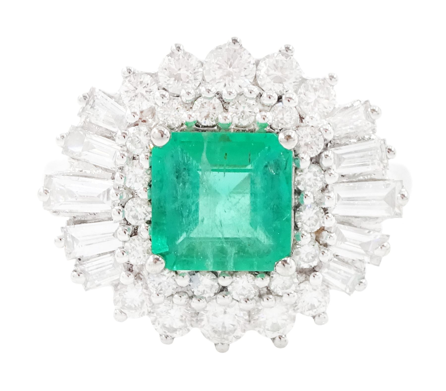 18ct white gold Colombian emerald and diamond cluster ring by Iliana, single octagonal cut emerald of 1.65 carat, surrounded by two rows of round brilliant cut and tapered baguette cut diamonds, hallmarked