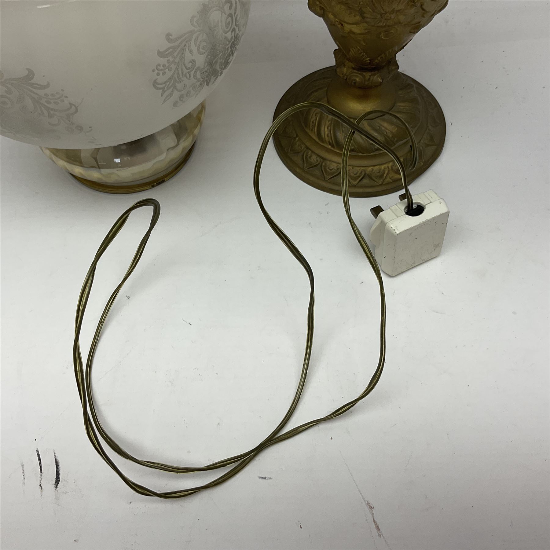 Gilt metal table lamp, heavily embossed with flowers and butterflies, with fluted frosted glass shade, H56cm