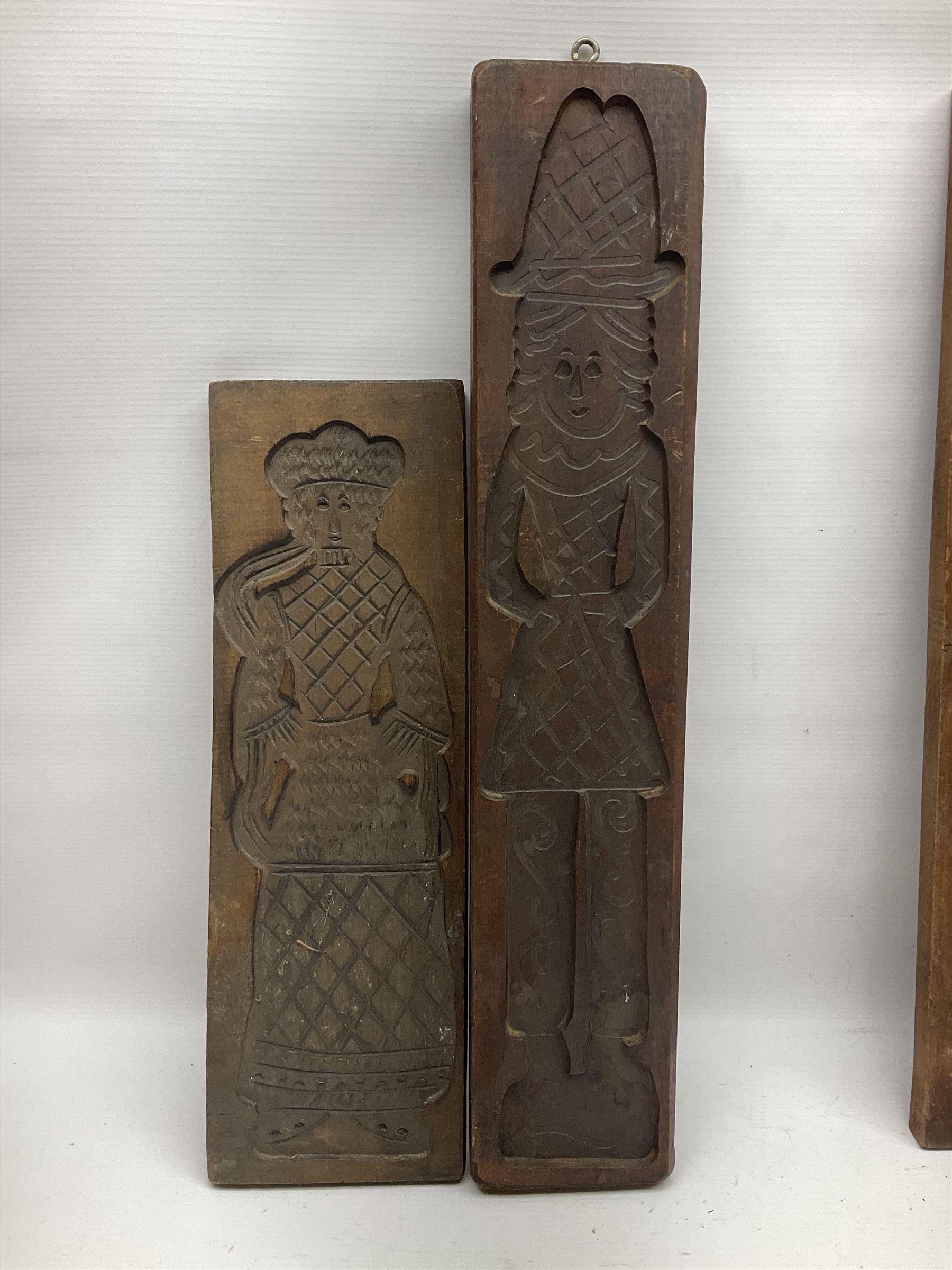 Eight 20th century hardwood Dutch folk art Speculaasplank or biscuit moulds, most examples typically carved with figures in traditional dress, tallest H60cm