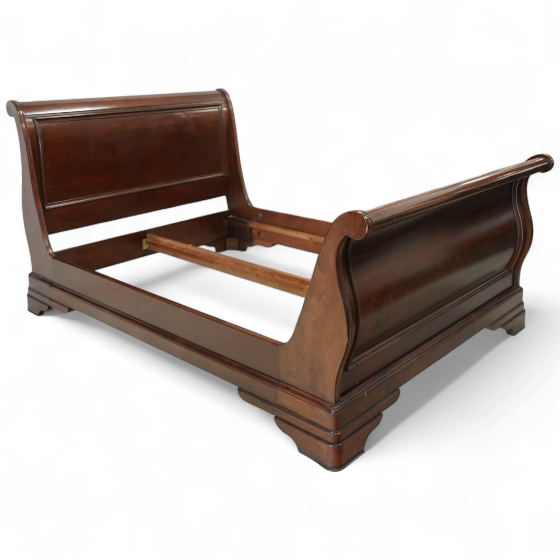 Late 20th-century mahogany Empire-style double sleigh bed, scrolled panelled headboard, and footboard, base with moulded plinth raised on bracket feet