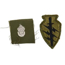 Selection of US army, navy  and air force insignia together with US Army WWII I.D. Tags on chain with British coins