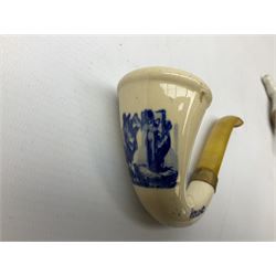 Carved meerschaum and amber pipe with silver mount, the bowl carved as a woman, cased, clay pipe in the form of an acorn, ceramic pipe, five other pipes and a ceramic bottle pourer in the form of a horse  