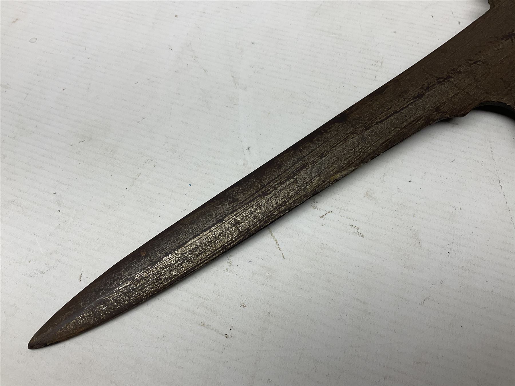 Moroccan jambiya dagger with 24.5cm plain curved blade stamped LONDON to the ricasso area, the hilt and scabbard overlaid with plain sheet brass to the back and ornate silver coloured metal to the front; waisted grip and arched pommel; two pyramid mounts to the scabbard L41cm overall; large billhook with curving blade and stacked leather washer grip; and a reproduction halberd blade (3)