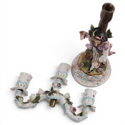 Pair of 19th Century German three-branch figural candlesticks, the figures each in floral dress against a tree, the branches decorated in relief with roses and the sconces painted with insects, H33cm 