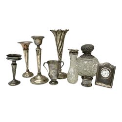 Group of silver to include wrythen twist vase with filled base, hobnail and octagonal cut glass scent bottle with repousse foliate cap stamped Birmingham 1900 and collar, silver mounted desk clock, napkin ring, presentation trophy cup, other filled silver and silver mounted glassware