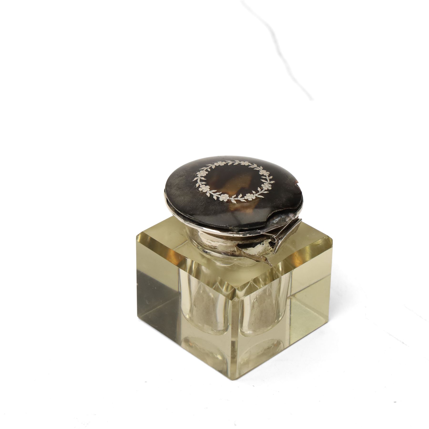 Silver circular ring box with hinged tortoiseshell cover, glass block inkwell with pique tortoiseshell cover Birmingham 1921 and a silver napkin ring (3)