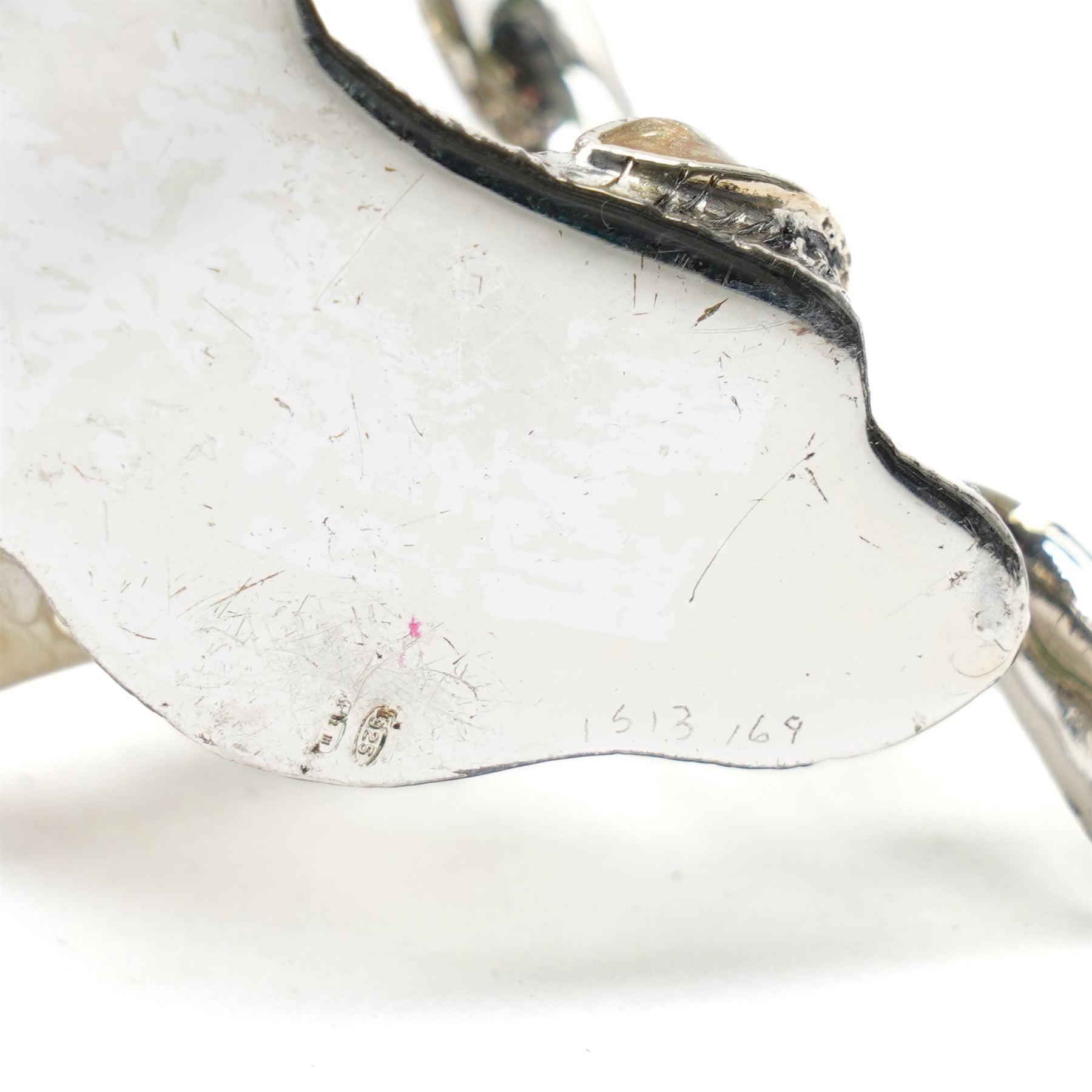 Silver and enamel model of a mallard taking flight from bulrushes and on a naturalistic base  H7cm x W7cm marked 925