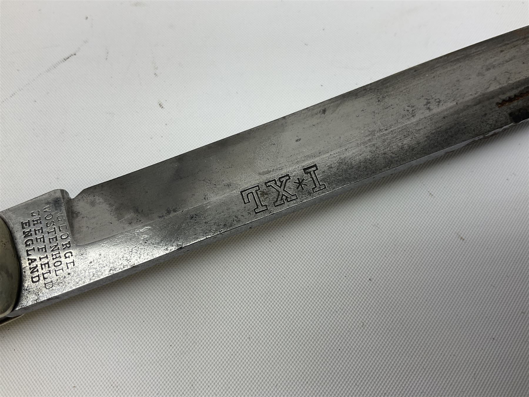 Hunting knife by J Nowill & Sons, Sheffield, the handle inset with mother of pearl, blade length 19cm; George Wolstenholme IXL lock-knife with antler scales L29cm open; and another Bowie style hunting knife marked 'V.R. Warranted Sheffield Joseph Ellis & Sons' in leather sheath (3)