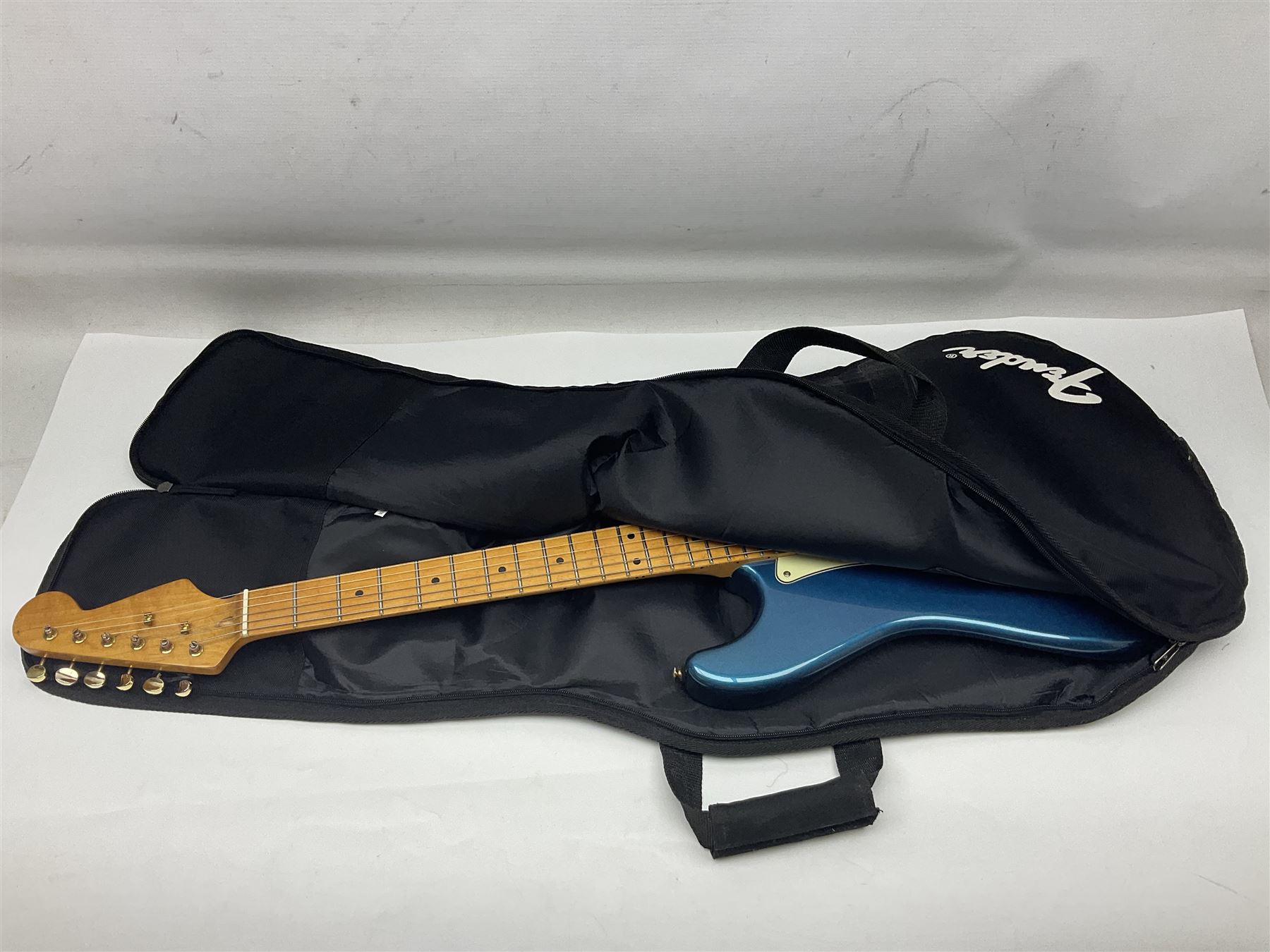 Fender Stratocaster style electric guitar in metallic blue with Rio Grande pick-ups and Fender back-plate L98cm; in Fender soft carrying case