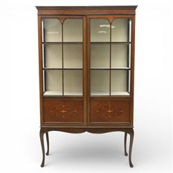 20th century Edwardian style mahogany display bookcase cabinet, the moulded cornice above two lancet glazed doors enclosing a shelved interior, the lower sections with oval inlaid fan decoration, supported on shaped cabriole legs