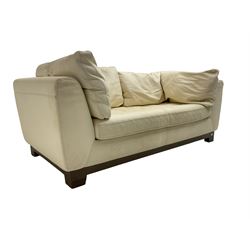 Roche-Bobois - two seat sofa, upholstered in ivory leather with buttoned seat cushions, raised on a stained beech base with bracket feet