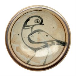 Studio pottery bowl, probably by Svend Bayer of Wenford Bridge, the stoneware body of shallow circular footed form with brushwork decoration of a stylised bird figure in grey upon peach ground within bands of iron red, unmarked, D18.5cm