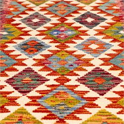 Afghan Chobi flatweave kilim runner, with a repeating stepped diamond medallion design in ivory, green, rust, teal, purple, indigo, and framed by chevron and geometric borders