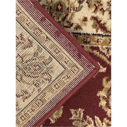 Contemporary Dunelm 'Legacy' ground rug, the field decorated with symmetrical scrolling foliate and floral motifs, bordered by an ivory band with repeating floral designs interspersed with leafy branches, inner guard stripe with fine linear patterning