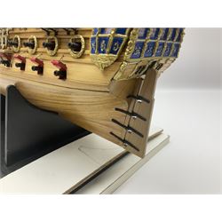 Wooden kit built model of HMS Neptune, 1:90 scale, with detailed rigging to three masts and a row of cannons to either side, upon ebonised wooden base, including stand H71cm