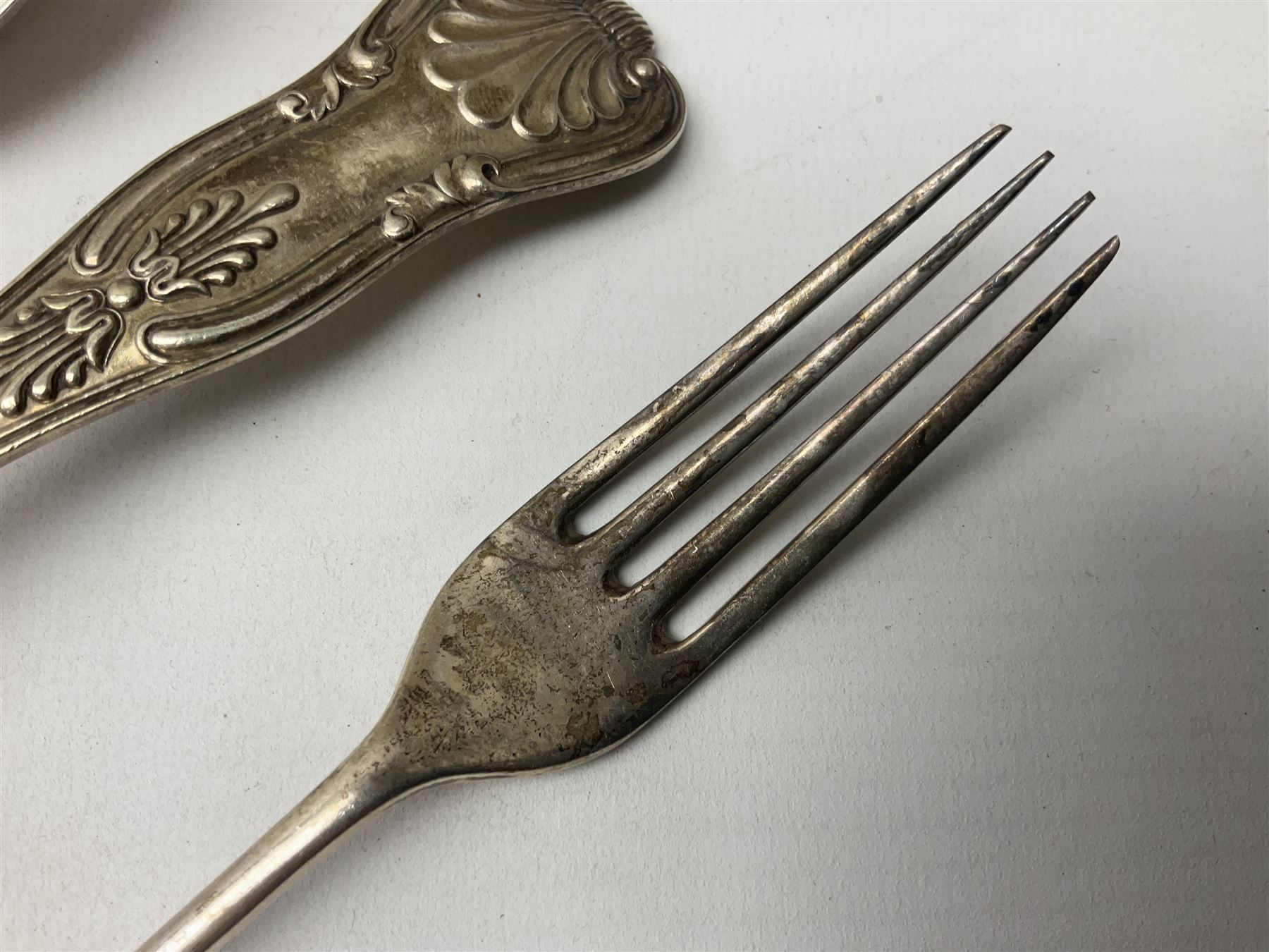 Edwardian silver dessert fork, and silver dessert spoon, hallmarked Sheffield 1905, and 1908, together with a mid 20th century coffee spoon, hallmarked Sheffield 1954, and a silver plated Kings pattern table spoon, approximate total silver weight 108 grams