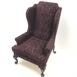 Traditional Queen Anne style high wingback armchair upholstered in purple fabric with raised scrolling pattern, on cabriole feet