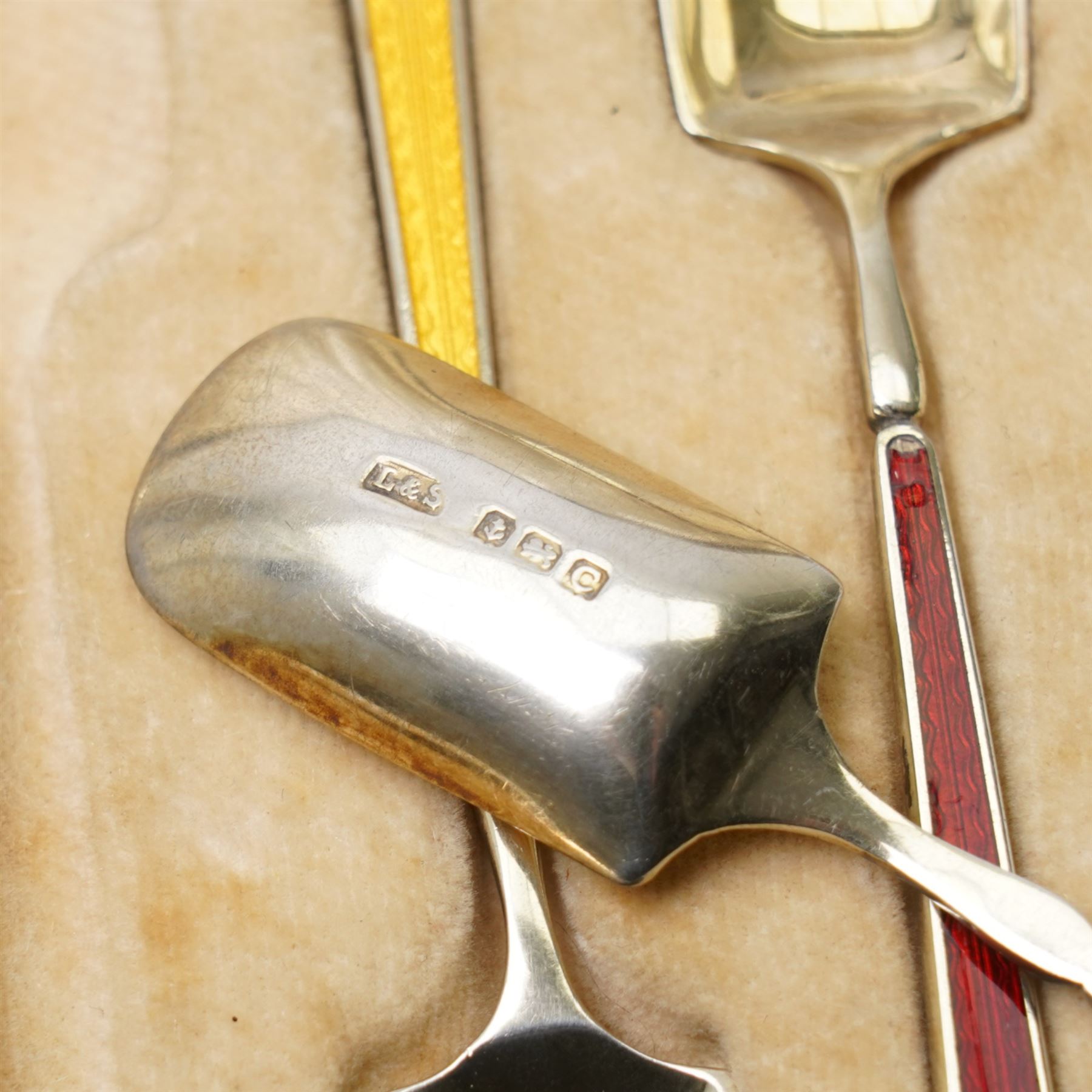 Set of six silver gilt coffee spoons with spade shape bowls, each stem with different coloured enamel and in original case Birmingham 1926/27 Maker Levi & Salaman
